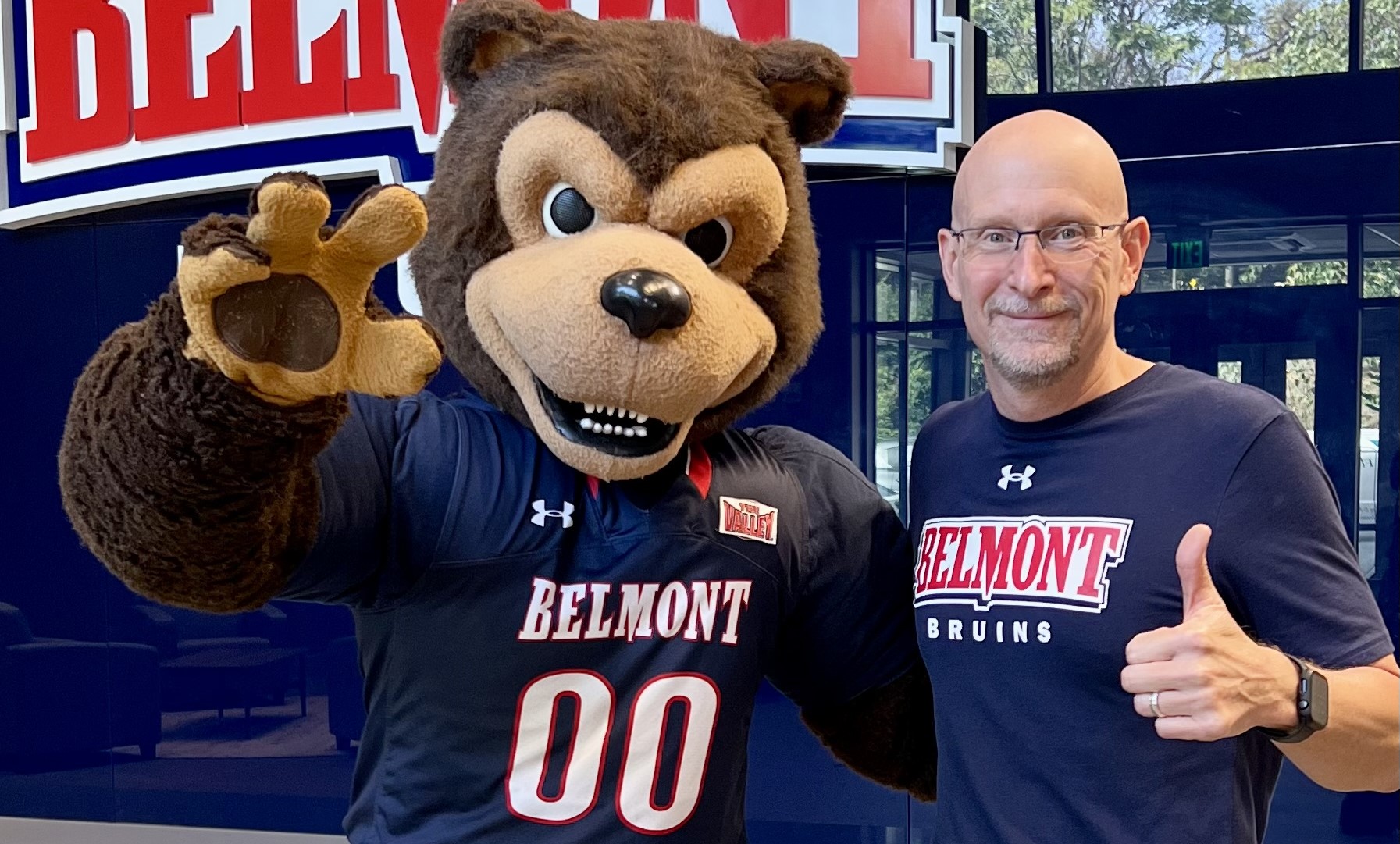 John Browning, Pro-Care President, poses with Bruiser, the Belmont mascotl