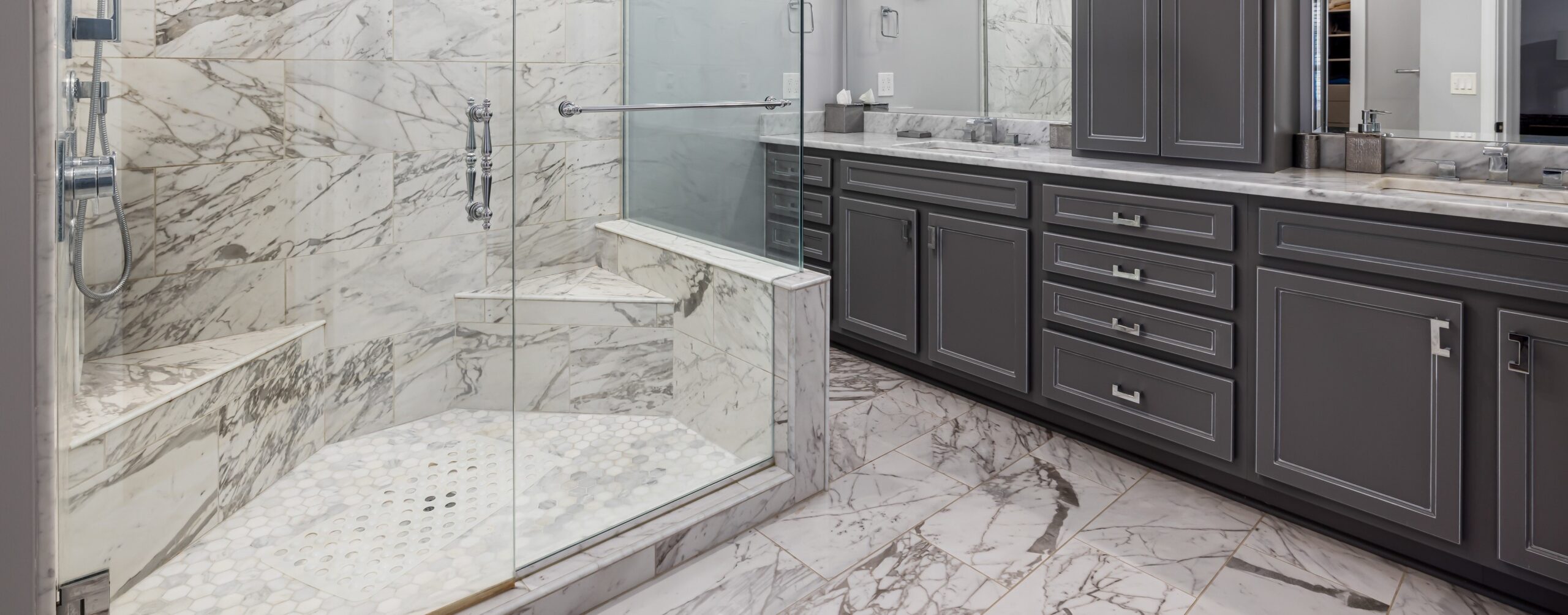 Primary baths are a great place to show off natural stone, whether in showers, on floors or on countertops.