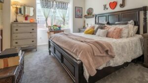 Carpet complements cottage core primary bedroom.